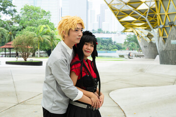 Cosplayers embracing in urban park setting