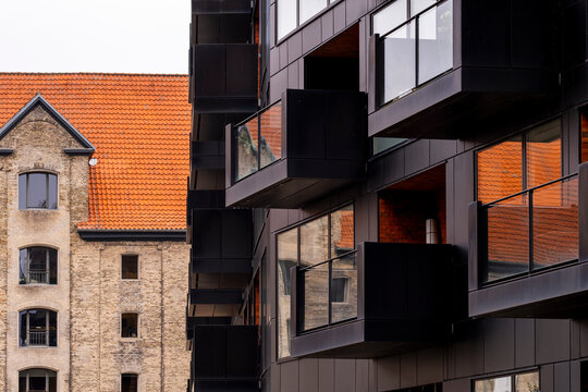 Juxtaposition of modern architecture and historic building elements in Copenhagen creating visual contrast and rhythm, ideal for editorial or branding layouts