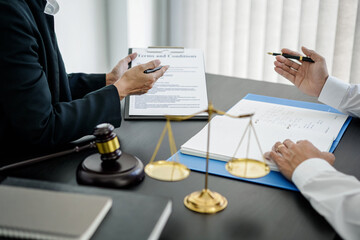 Female lawyer is pointing on legal document to explaining about legal consultation, terms and condition to businessman