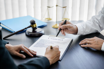 Female lawyer and businessman signing on contract after discussion about terms, condition and legal document