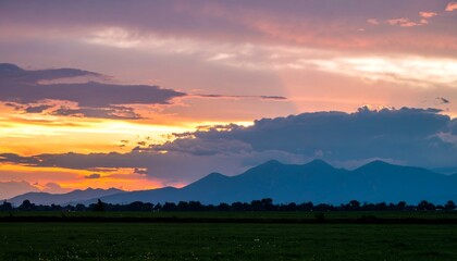 Colorful sunset over a field with vibrant sky background and horizon
