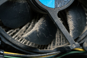Dusty computer cooling fan and motherboard close up, dirty PC hardware component in need of cleaning and maintenance