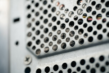 Close-up of dusty ventilation grill on the back of an old computer case, dirty PC cooling system covered with dust and lint

