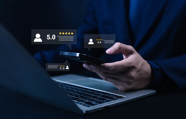 Businessman using smartphone and laptop with customer feedback and star rating icons, concept for online review, reputation management, user experience, and digital marketing analytics.