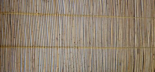 bamboo mat texture, showcasing natural vertical bamboo sticks woven together in a traditional pattern. Bamboo ceiling