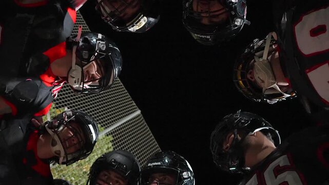 American football team huddling together before a match