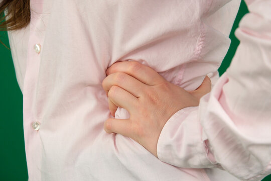 Collection of closeup hand movements of young European woman in pink shirt on green chroma key background showing different gestures open palms folded hands and expressive poses with copy space. - Powered by Adobe
