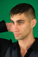 Collection of videos with fit European man in black t shirt and white pants on green chroma key background expressing various emotions smiling thinking surprised serious and confident poses.