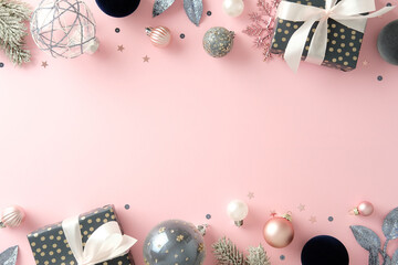 Christmas holiday flat lay with frosted pine branches, silver glitter ornaments, and wrapped gifts on pink background. Xmas banner design.