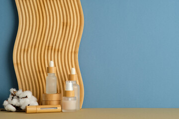 Elegant frosted glass bottles with wooden caps and cotton accents, perfect for organic skincare branding and wellness product visuals.