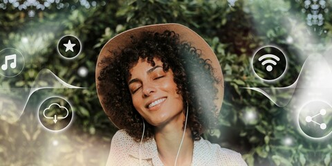 Beautiful woman listening to music in a botanical garden