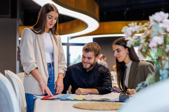 Fototapeta Design team collaborating on fabric swatches for interior project