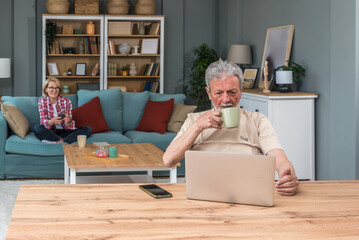 Senior couple, older people simple living, sitting at home, using technology for first time,...