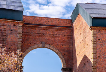 Fototapeta premium A large arch in the wall of a brick building.