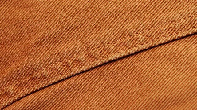Brown denim fabric, seam on jeans close-up. High quality 4k footage