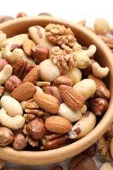 Mix of different nuts in bowl on table, closeup