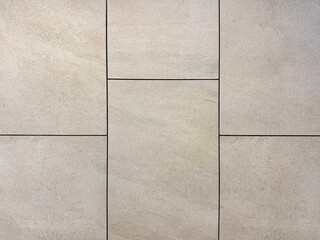 Close up of grey stone tiles with black grouts. Natural light grey stone slate tiles with rough surface. Seamless background texture.