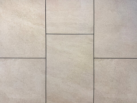 Close up of grey stone tiles with black grouts. Natural light grey stone slate tiles with rough surface. Seamless background texture.