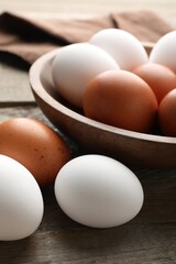 Fresh chicken eggs on wooden table, closeup