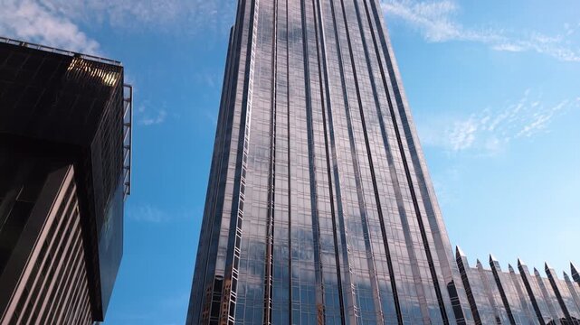 Looking up at the stunning high-rise building with glass fa&ccedil;ade at the backdrop of blue sky. Low angle view at One PPG Place in Pittsburgh, Pennsylvania, USA.