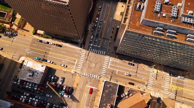 Crossroad among the high-rise buildings in the city. Top view. Lots of cars stand at the parking lot. Pittsburgh, Pennsylvania, USA.