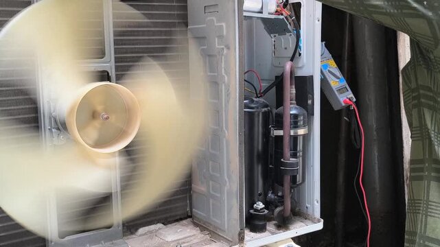 An AC technician carefully fills refrigerant gas into the outdoor unit, ensuring optimal cooling performance. Learn professional air conditioning maintenance techniques for efficiency and long-lasting
