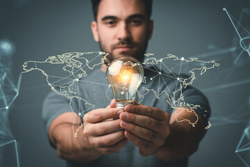 Man holding lightbulb with world map global business innovation technology solutions concept idea growth 100