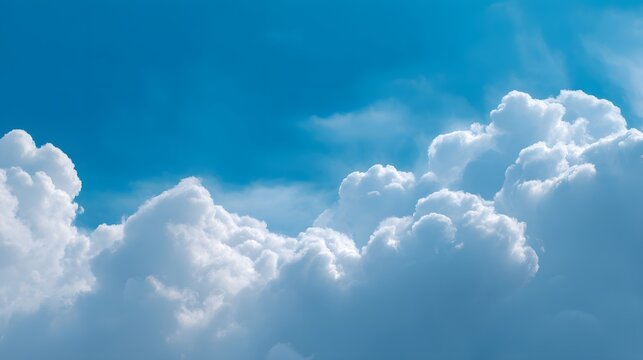 Brilliant fluffy white clouds gracefully drift across a vast, vibrant, and clear cerulean blue sky, creating a breathtaking scene of pure atmospheric beauty under bright, natural daylight.