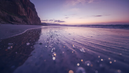 Macro wide angle of wet coastline with shimmering ripples at sunset