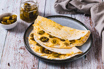Cheese and jalapeno mexican quesadillas on a plate on the table