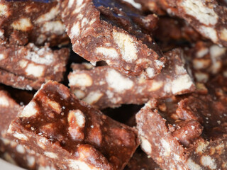 Close-up of blocks of chocolate brownie and biscuit sweets stacked on top of each other