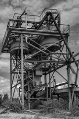 Dilapidated and abandoned industrial installation in monochrome