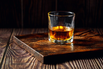 Strong alcohol drink. Whisky in glass, liqueur, bourbon or cognac. Hard strong alcoholic drink