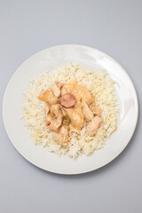 chicken stroganoff with boiled rice on plate