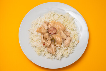 chicken stroganoff with boiled rice on plate