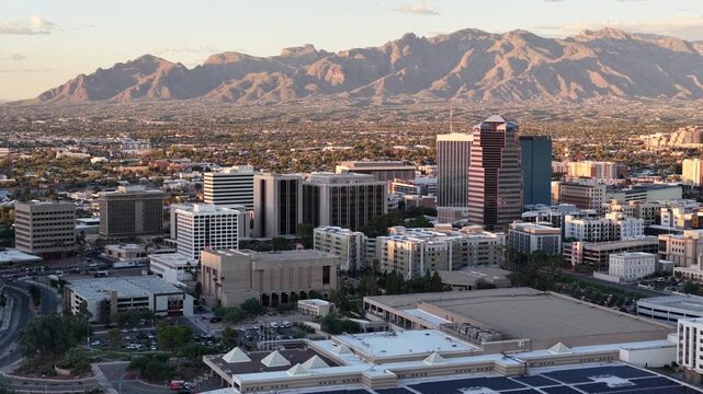 Wide descending circular push towards Downtown Tucson, Arizona Close to Sunset with Catalina Mountains in Background