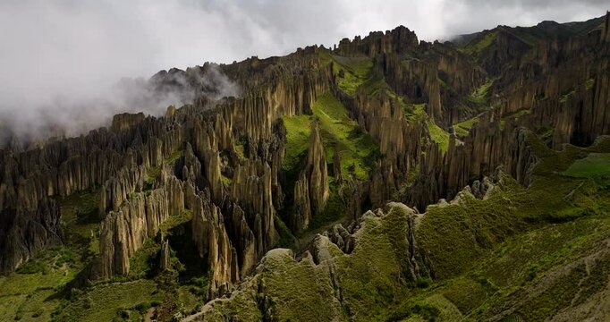 Rock formations in Valle de las Animas, Valley of the Souls, clouds and fog over unique geological spires near La Paz, Bolivia. Aerial drone panoramic view