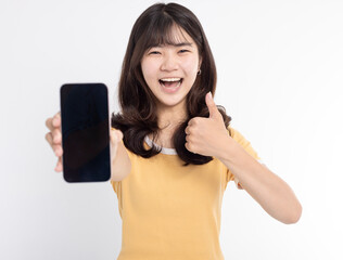 Asian girl showing or presenting mobile phone application and thumbs up isolated over white background