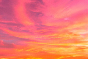 Fototapeta premium The sunset sky is a beautiful mix of pink, yellow, orange, gold and blue.