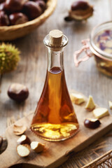 Herbal tincture made of fresh horse chestnut seeds in a glass bottle