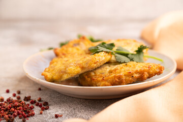 Fried crispy Chicken pancakes on brown concrete and orange textile. side view, selective focus