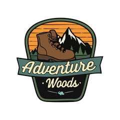 Adventure Woods Hiking Badge Featuring Boot and Mountain Landscape with Sunset Colors in a Retro Style Design