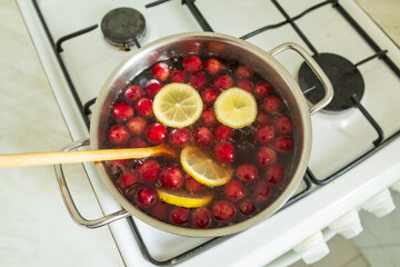 Stirring cherry soup with lemon slices