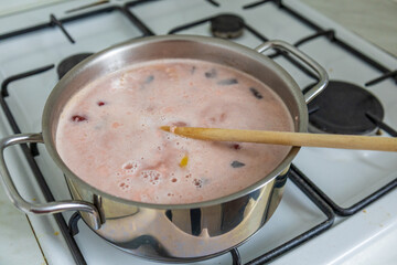 Cooking cherry soup with creamy pudding mixture.