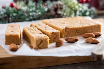 Christmas soft almond nougat bar with christmas decoration on wooden table