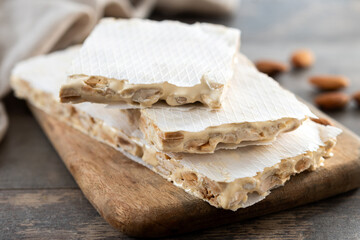 delicious almond nougat on wooden table. Traditional Christmas sweet