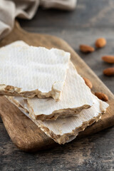 delicious almond nougat on wooden table. Traditional Christmas sweet