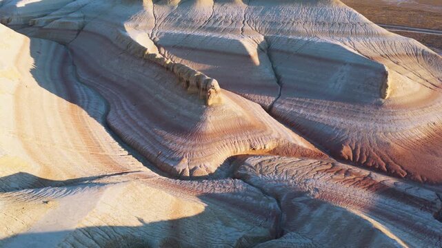 Aerial view of the layered rock formations showcasing an array of colors and textures, creating a mesmerizing landscape, Tiramisu, Mangystau Region, Kazakhstan.