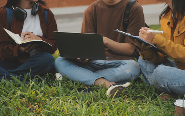 Happy students walking together on university campus, chatting and laughing outdoors after classes