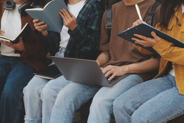 Happy students walking together on university campus, chatting and laughing outdoors after classes